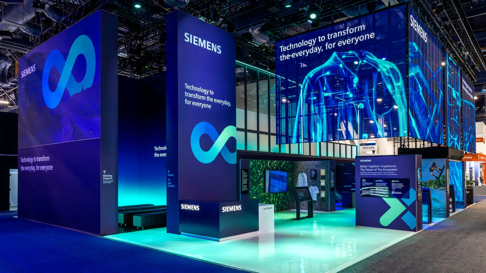 Sparks-designed Siemens exhibit at CES 2025 with infinity-loop towers and a glowing teal floor