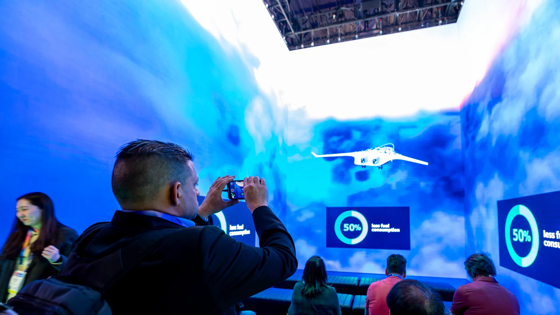 Attendee films a blended-wing aircraft inside the Sparks-built LED theater with 50% callouts