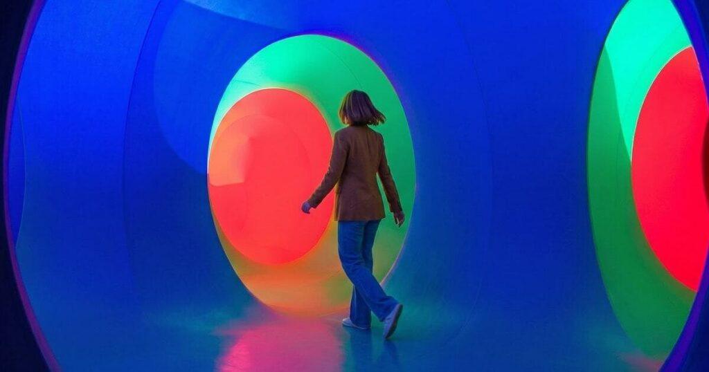 Multi-sensory brand environment in a Sparks-designed healthcare exhibit — layered lighting, texture, and spatial design engaging HCPs beyond the visual channel.