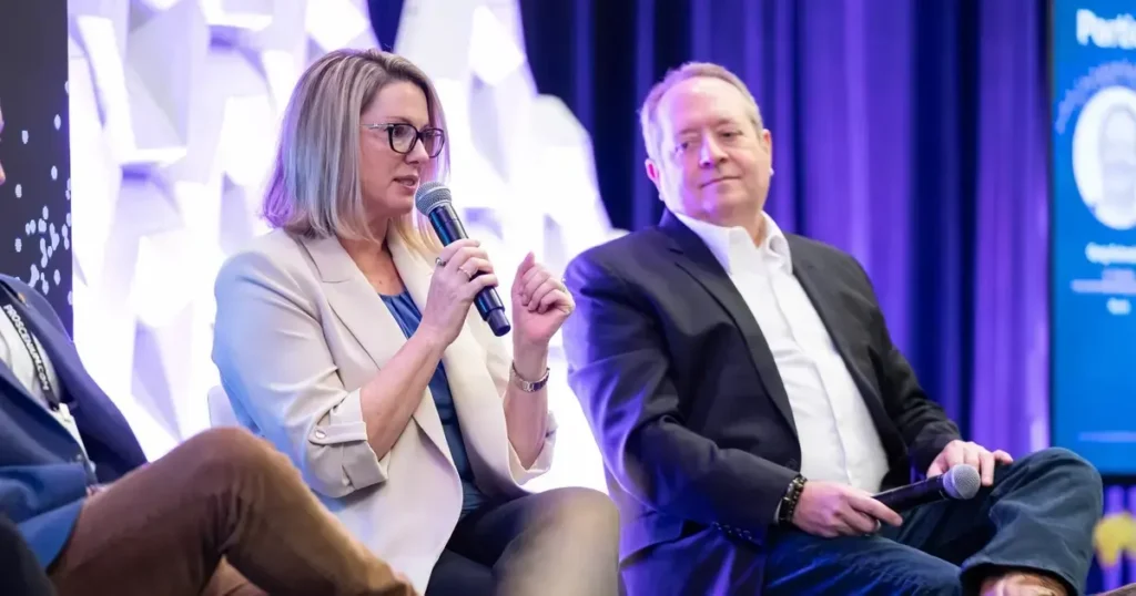 Yvonne Marquez, Global Head of Experiential Marketing at Dolby, speaks on a panel at the 2026 Sparks Executive Forum, with Greg Schneider of Boomi listening