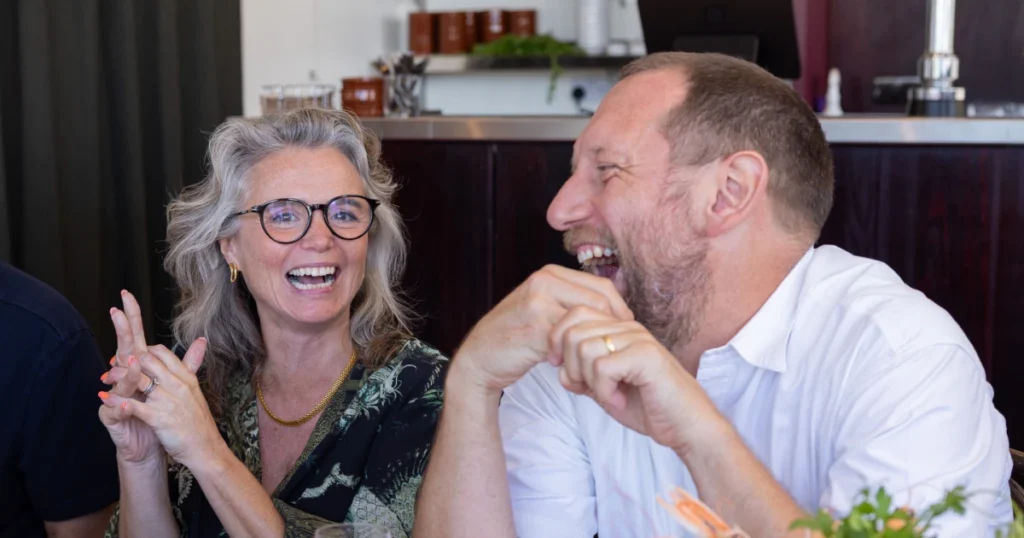 Two Sparks guests share a laugh during the shared Fruits de Mer lunch at Angela's in Margate during the UK Creative Festival 2026.