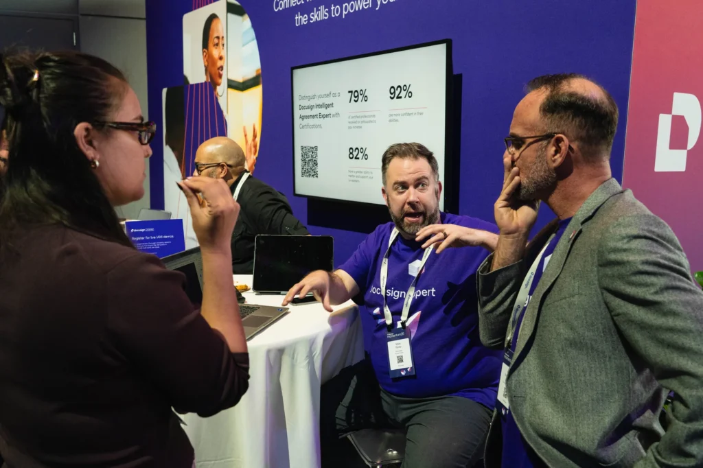 A Docusign expert demonstrating the Intelligent Agreement Management platform to attendees at the Momentum 2026 Agreement Expo.