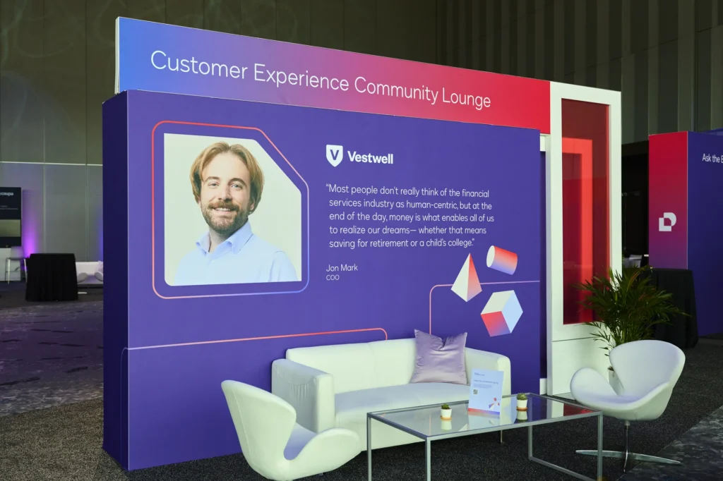 The Customer Experience Community Lounge at Docusign Momentum 2026, featuring a customer quote and lounge seating.