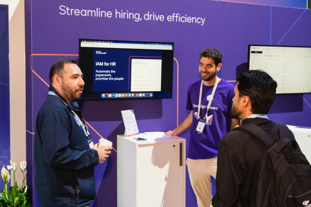 IAM for HR demonstration—"Streamline hiring, drive efficiency"—with a Docusign expert and attendees at Momentum 2026.