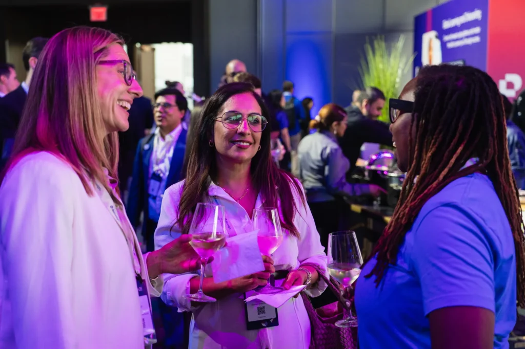 Attendees networking with drinks during an evening reception at Docusign Momentum 2026.