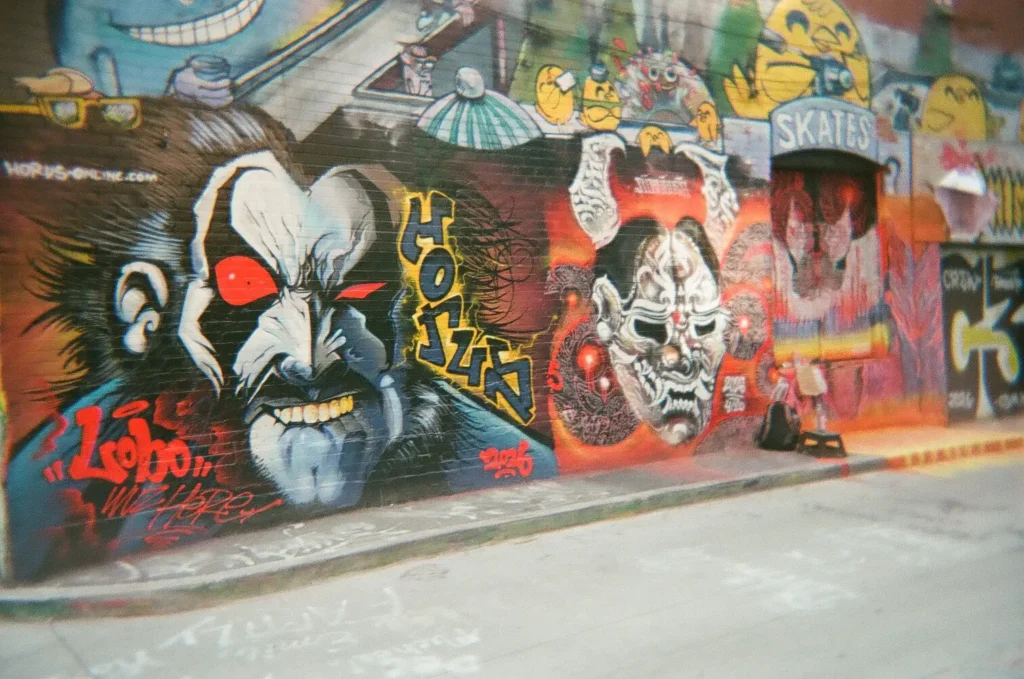 Sparks-hosted CEMA Summit 2026 disposable-camera photo — a KISS-band-inspired painted mural in Toronto's Graffiti Alley, captured by a CEMA Summit attendee on the Sparks-led walking tour.