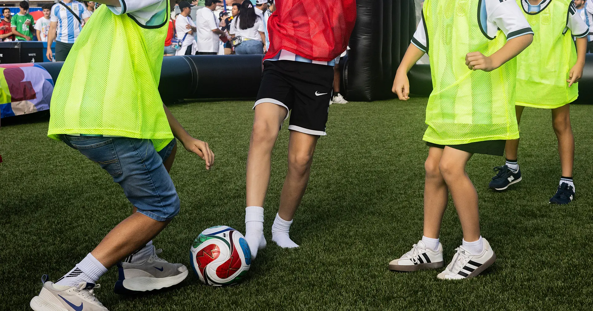 Young fans play a match on the Sparks-produced inflatable mini-pitch with FIFA World Cup 2026 branding at the Stadium Fan Experience Town Square outside Hard Rock Stadium at the FIFA World Cup 2026 Miami host city.