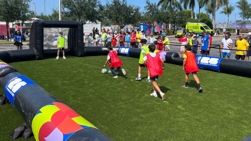 Young fans play a match on the Sparks-produced inflatable mini-pitch with FIFA World Cup 2026 branding at the Stadium Fan Experience Town Square outside Hard Rock Stadium at the FIFA World Cup 2026 Miami host city.