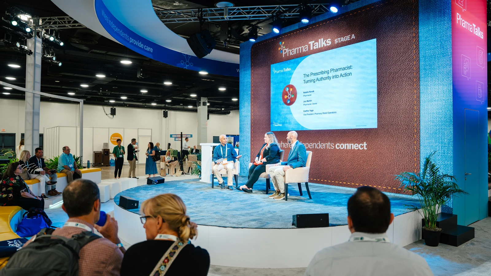A PharmaTalks Stage A theater session titled 'The Prescribing Pharmacist: Turning Authority into Action' on the Sparks-designed Main Street USA-themed McKesson ideaShare 2025 tradeshow floor at the Gaylord Opryland Resort & Convention Center in Nashville.