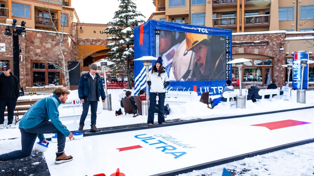 Interactive curling activation at Sparks-produced Base ULTRA Village, Canyons Village at Park City — Olympic-themed games and TCL-powered watch parties bringing Team USA fans together during the Milano Cortina 2026 Winter Olympics.