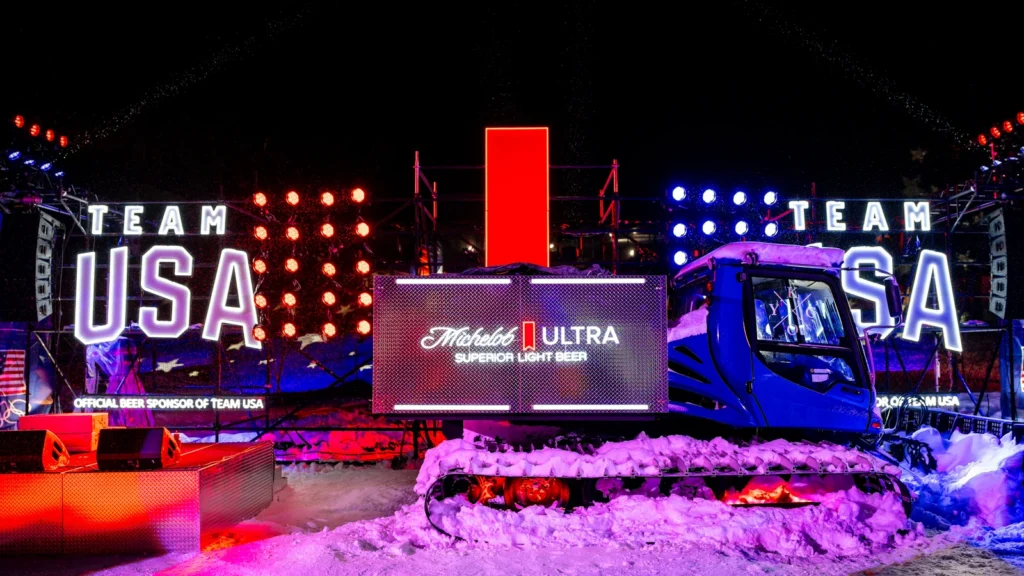 Custom-branded Michelob ULTRA snowcat at Sparks-designed ULTRA Summit takeover, Canyons Village at Park City — "Superior Light Beer, Official Beer Sponsor of Team USA" with illuminated Team USA letter installations at night.
