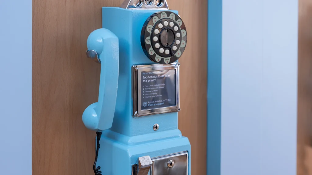 Vintage light-blue rotary payphone marked "Top 5 things to do after this photo" — the Sparks-designed "Talk to my agent" Agentforce activation at Salesforce Beach, Cannes Lions 2026.