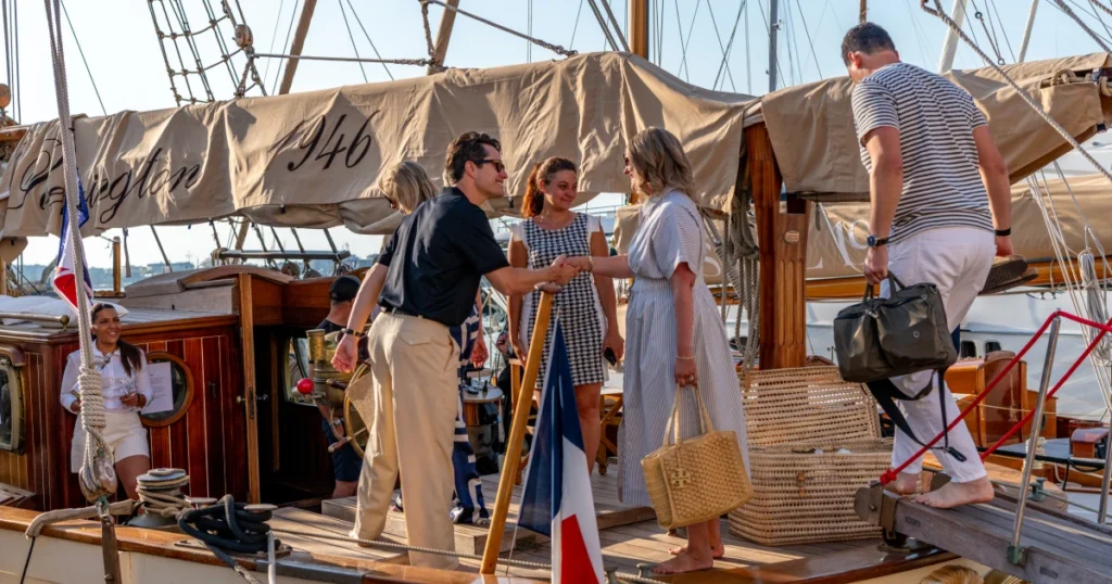 VIP guests boarding the O'Remington heritage schooner at Port Canto with the French flag flying beside the gangway at the Sparks-produced Riviera at Dawn breakfast cruise for The Wall Street Journal at Cannes Lions 2026.