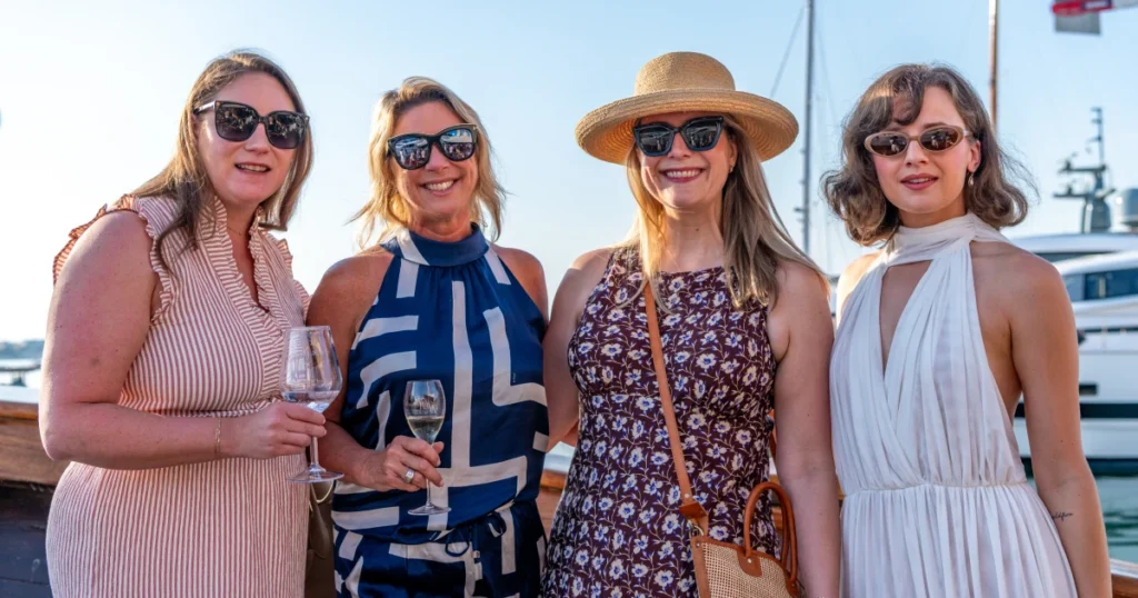 Four VIP guests in stylish Riviera dress with champagne aboard the O'Remington at golden hour at the Sparks-produced Riviera at Dawn for The Wall Street Journal at Cannes Lions 2026.