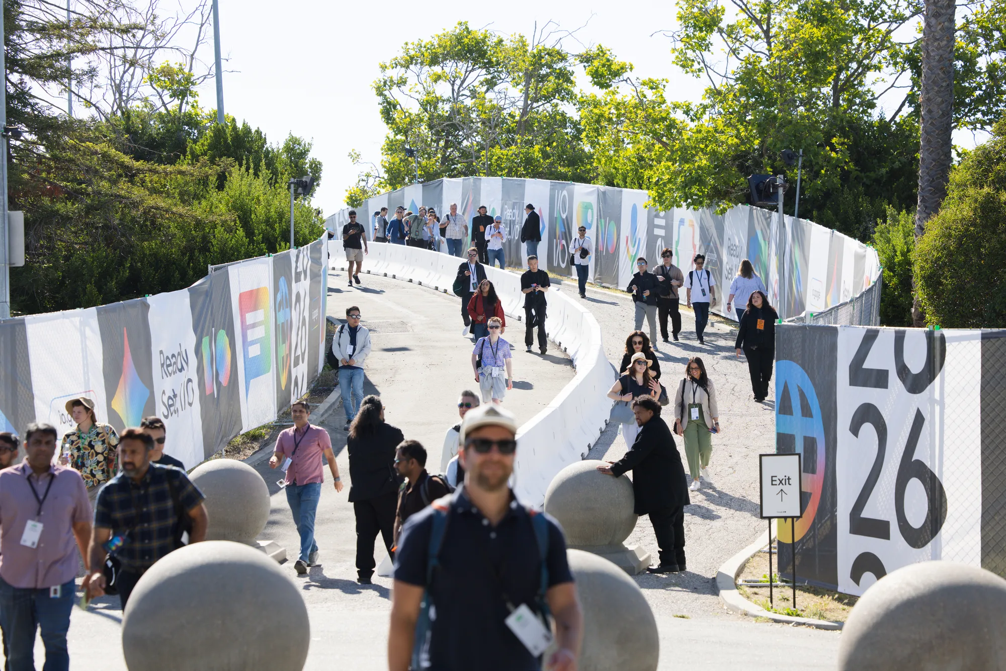 Attendees stream along a winding branded walkway lined with oversized 2026 graphics