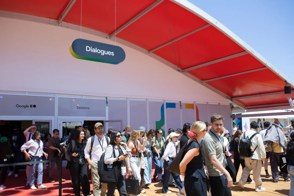 Attendees stream out of the red-canopied Dialogues structure between sessions
