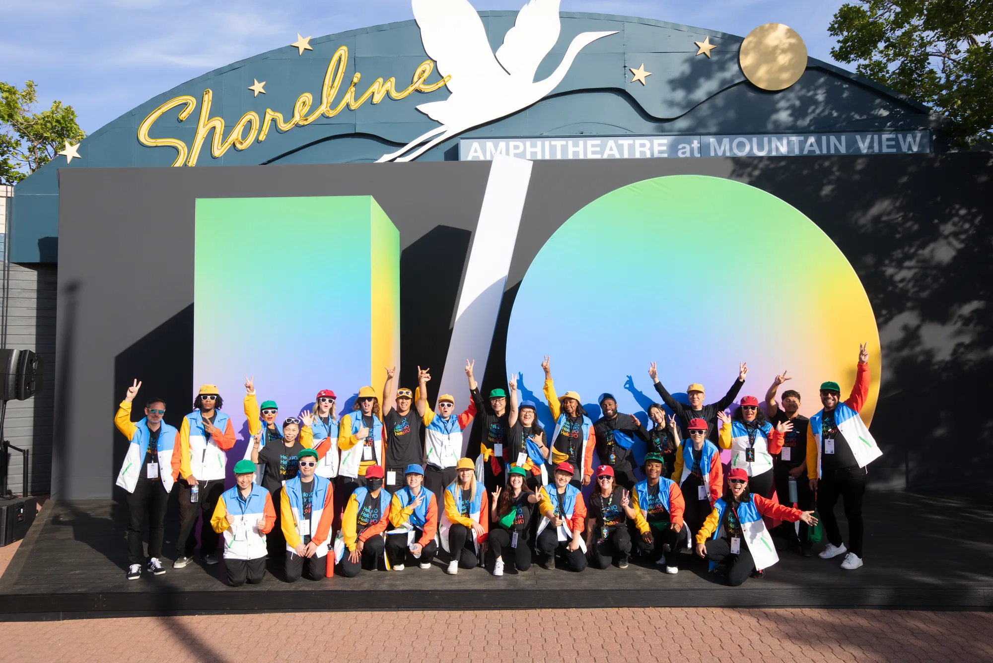 Google I/O 2026 brand ambassadors celebrate at the I/O sign at Shoreline Amphitheatre