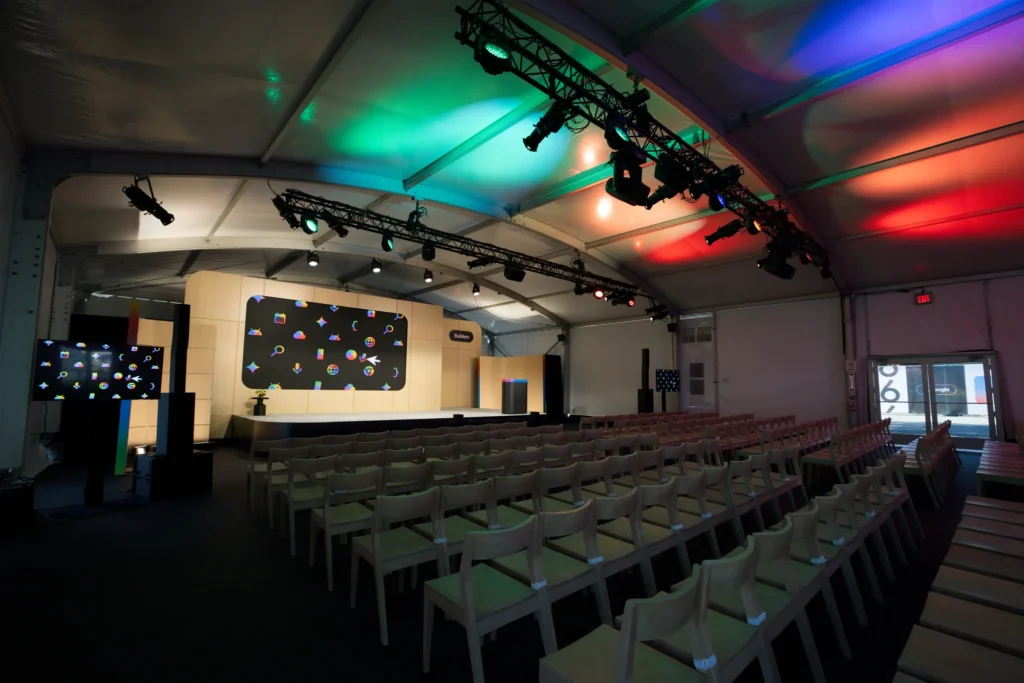 Empty session theater with rows of chairs and colorful stage lighting before doors open