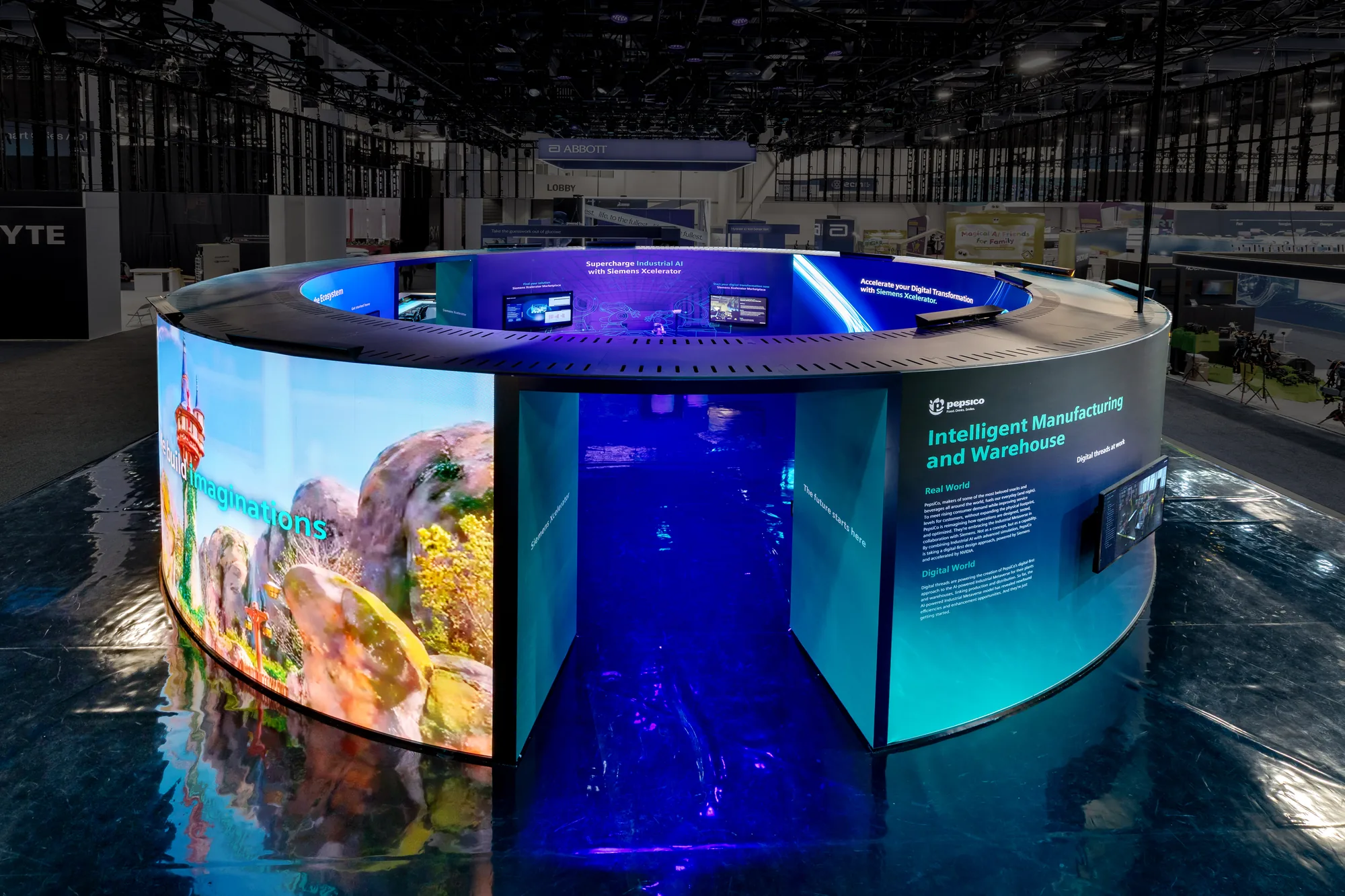 The circular Siemens Xcelerator environment at CES 2026, wrapped in curved LED and a PepsiCo customer story panel.