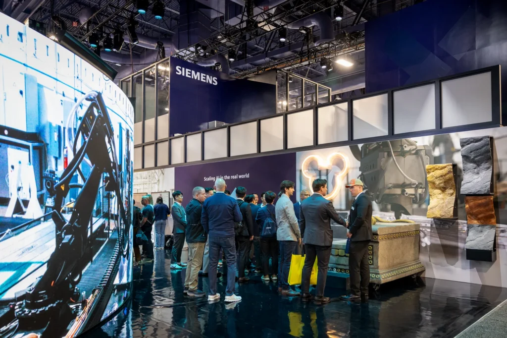 Attendees gathered around Disney's King Louie throne, created by Haddy, in the "Scaling AI in the real world" zone at Siemens CES 2026.