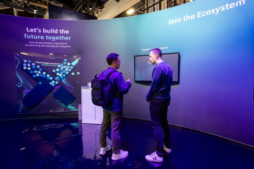 Attendees at the Siemens "Let's build the future together" idea-sharing interactive and "Join the Ecosystem" wall at CES 2026.