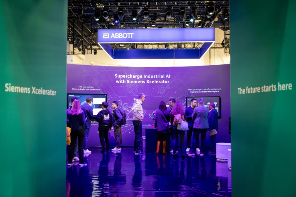CES 2026 attendees inside the Siemens Xcelerator environment, framed by walls reading "Siemens Xcelerator" and "The future starts here."