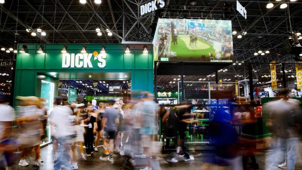 The Sparks-designed and built DICK'S Sporting Goods activation at Fanatics Fest 2026 at the Javits Center in New York — the 15,000-square-foot House of Sport branded entry archway with fans streaming past in motion blur, one of the most-visited destinations at the record-setting 200,000-fan festival.