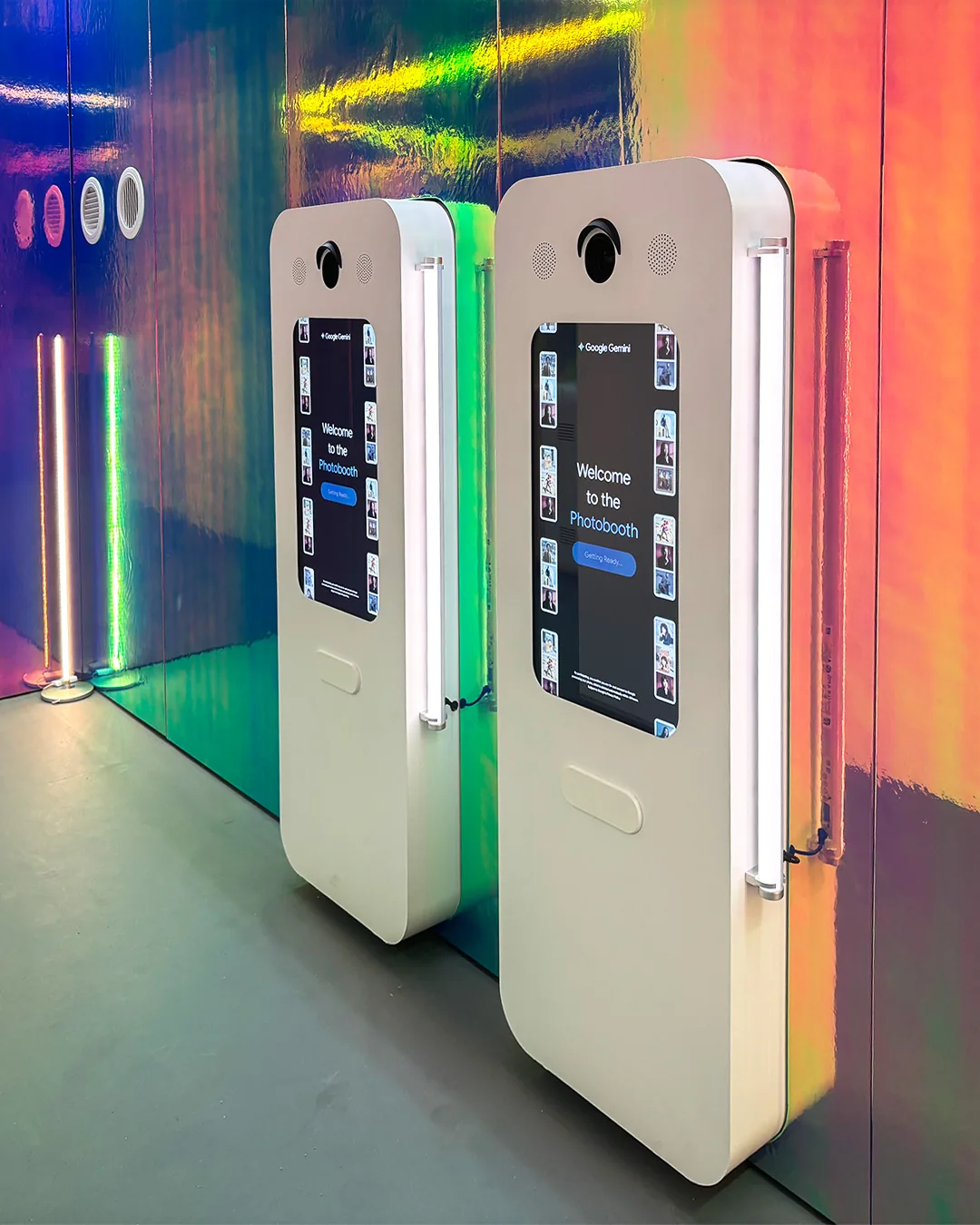 Two Nano Banana photo kiosks with touchscreens inside the mirrored Gemini space