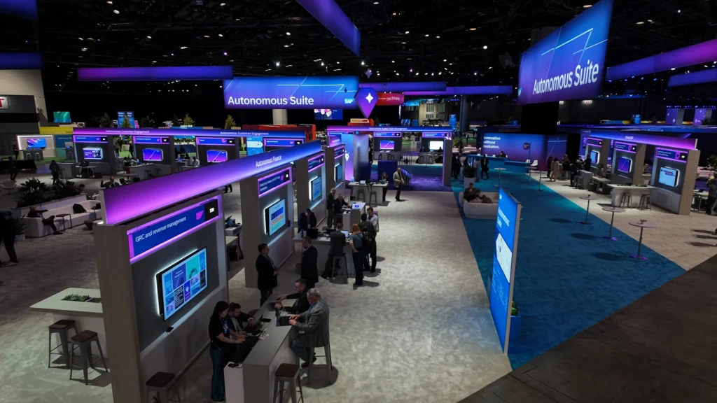 Elevated view of Autonomous Suite demo stations along a blue aisle at SAP Sapphire