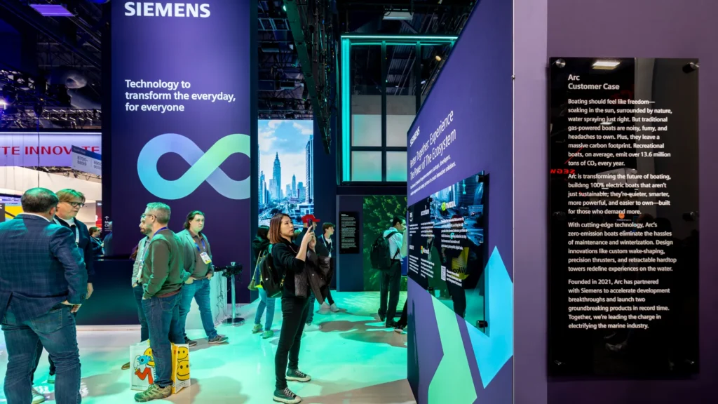 Visitors browse the ecosystem wall next to the Arc customer case plaque at CES