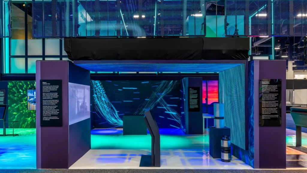 Archway with flowing water-pattern LED panels and a kiosk in the Wayout story zone