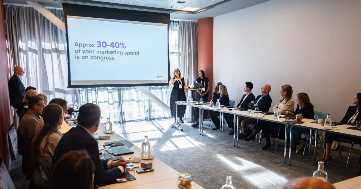 Presenter shows a slide noting roughly 30–40% of marketing spend goes to congress