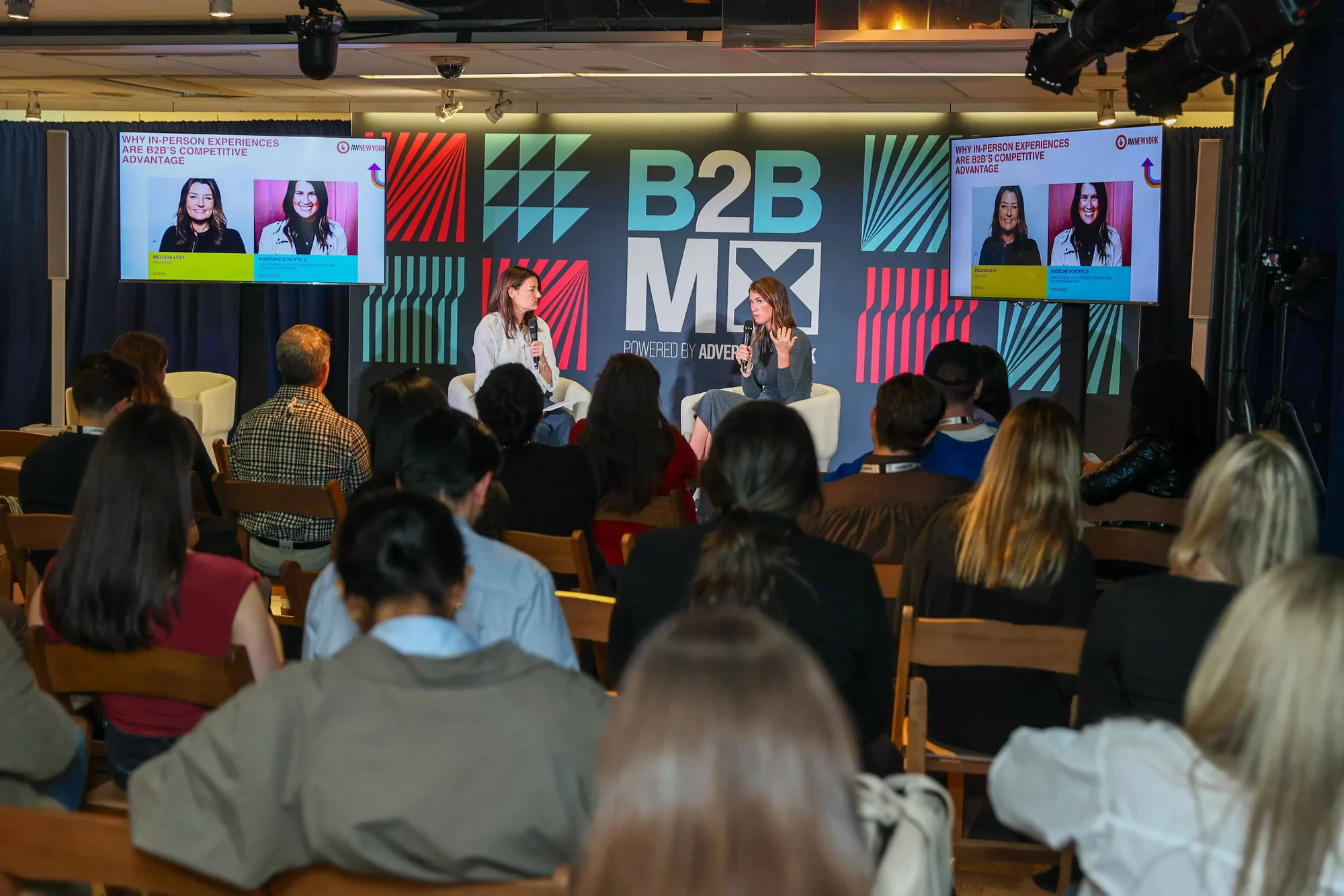 Seated audience watches Salesforce and Sparks leaders speak on the Advertising Week B2BMX stage