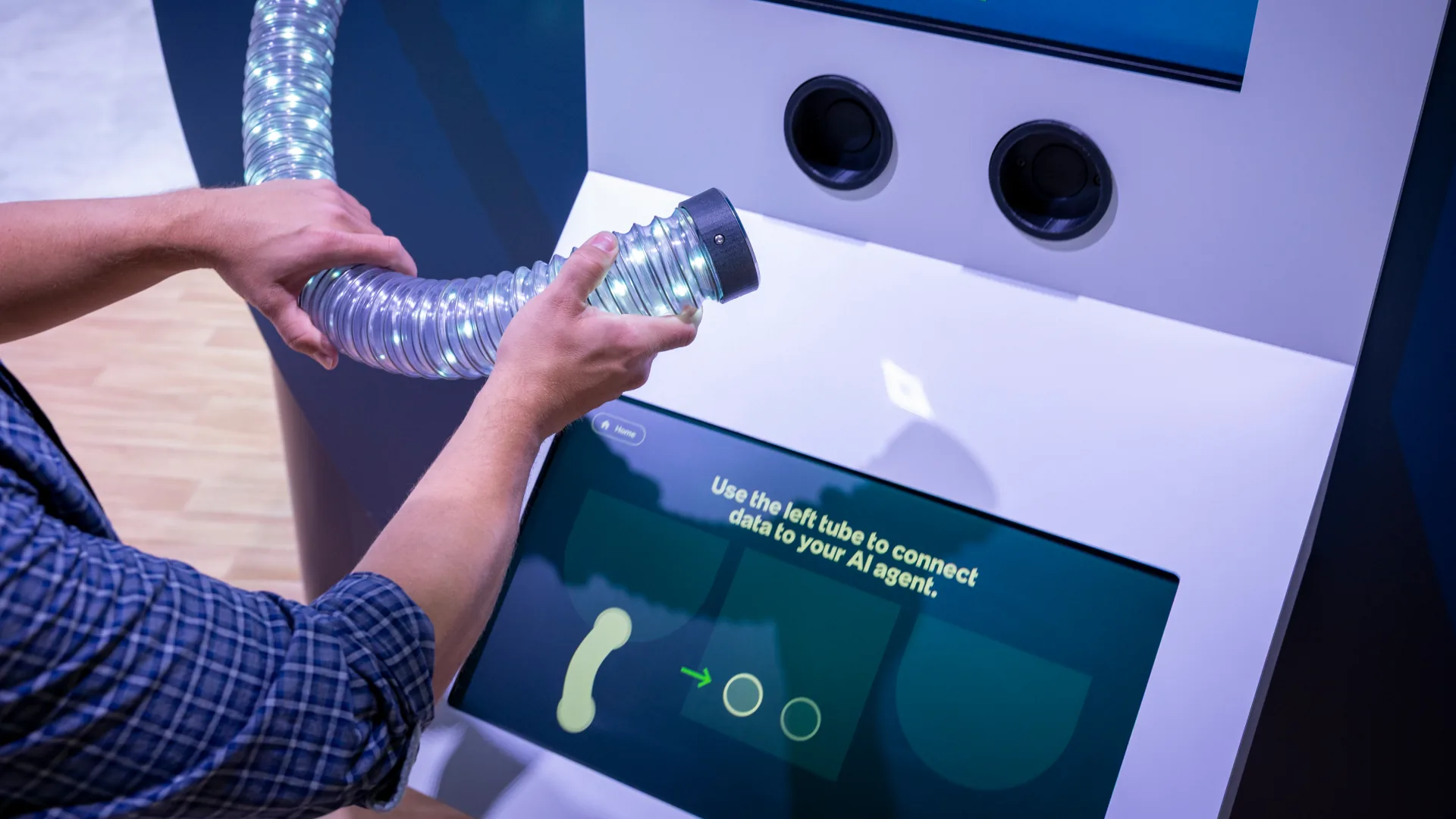 Hands lift a flexible LED tube to connect data to an AI agent