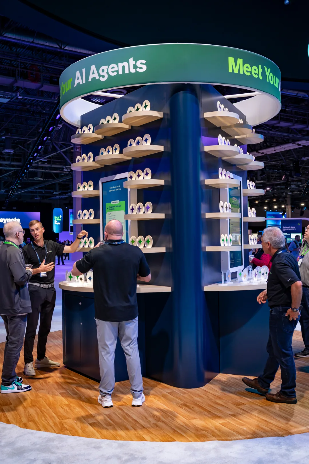 Attendees gather around a circular tower of sparkle discs at ServiceNow Knowledge 2025