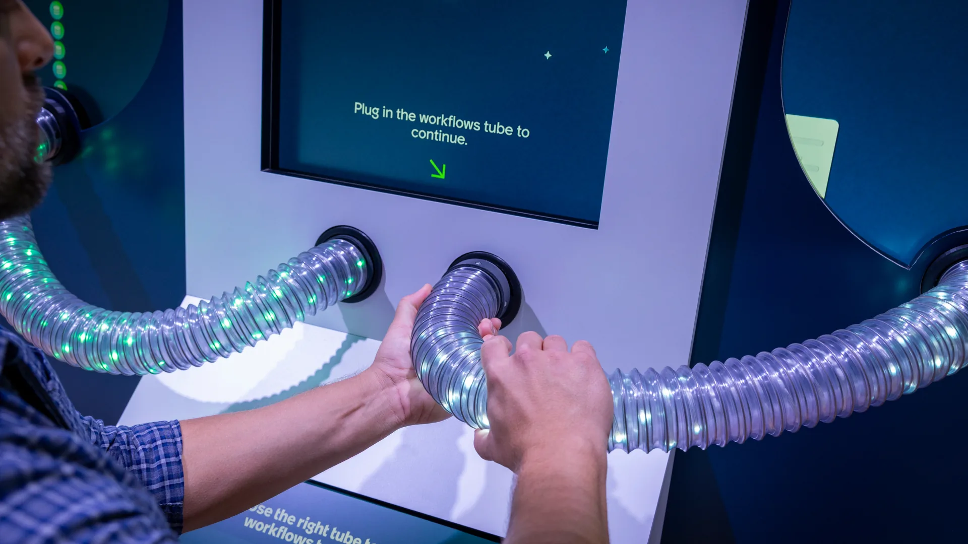 Visitor plugs a glowing LED tube into a port to connect AI workflows
