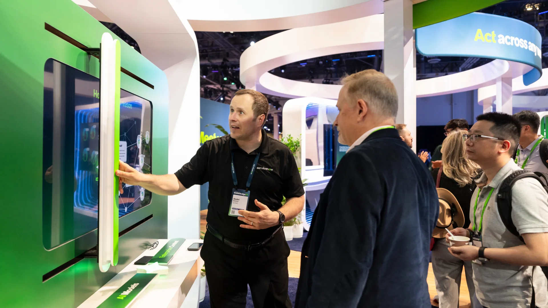 Staff member demonstrates a Sparks-built human-scale slider that reveals hidden data at Knowledge 2026