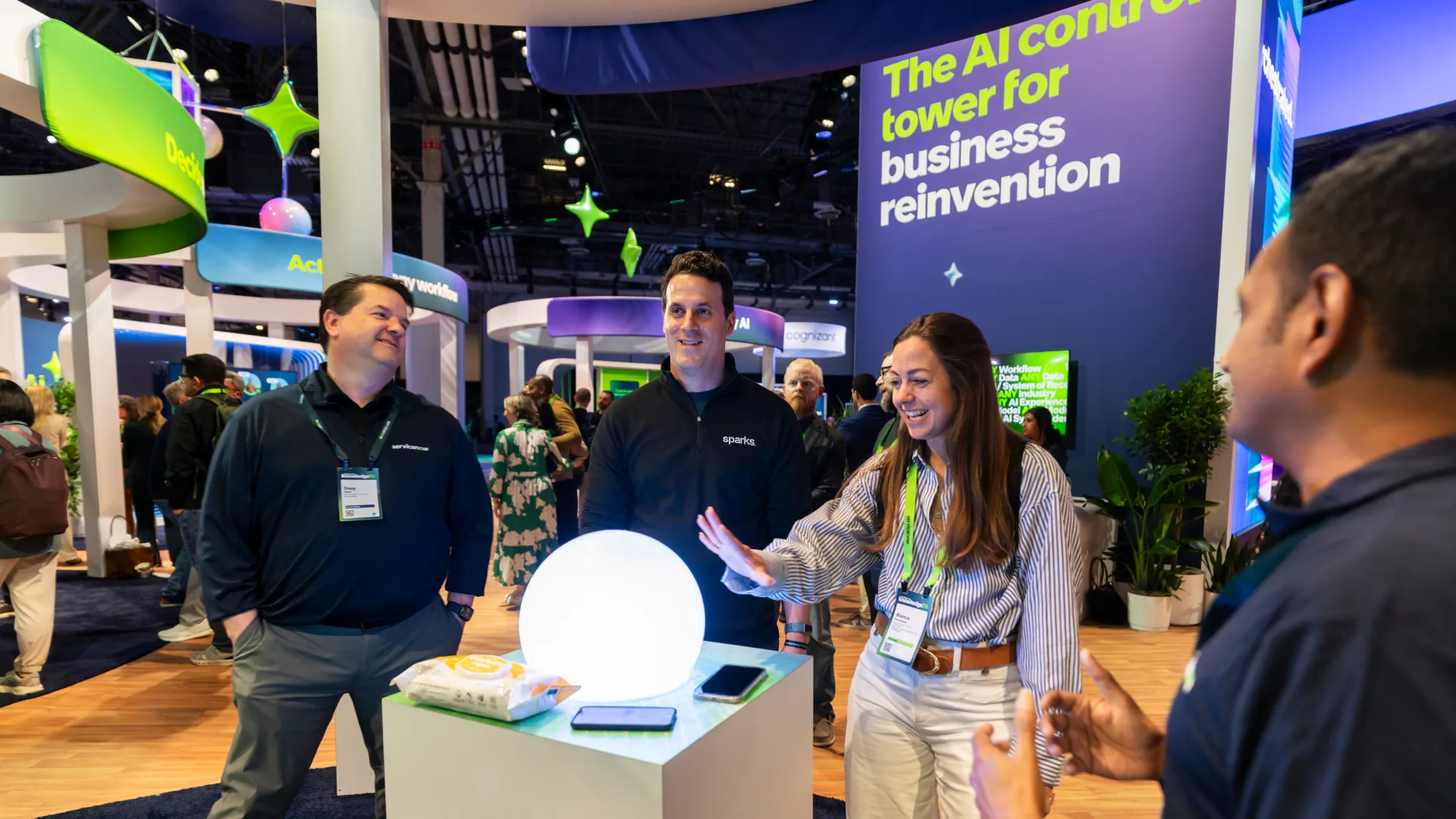 Attendees and staff gather around a glowing orb on a pedestal at Knowledge 2026